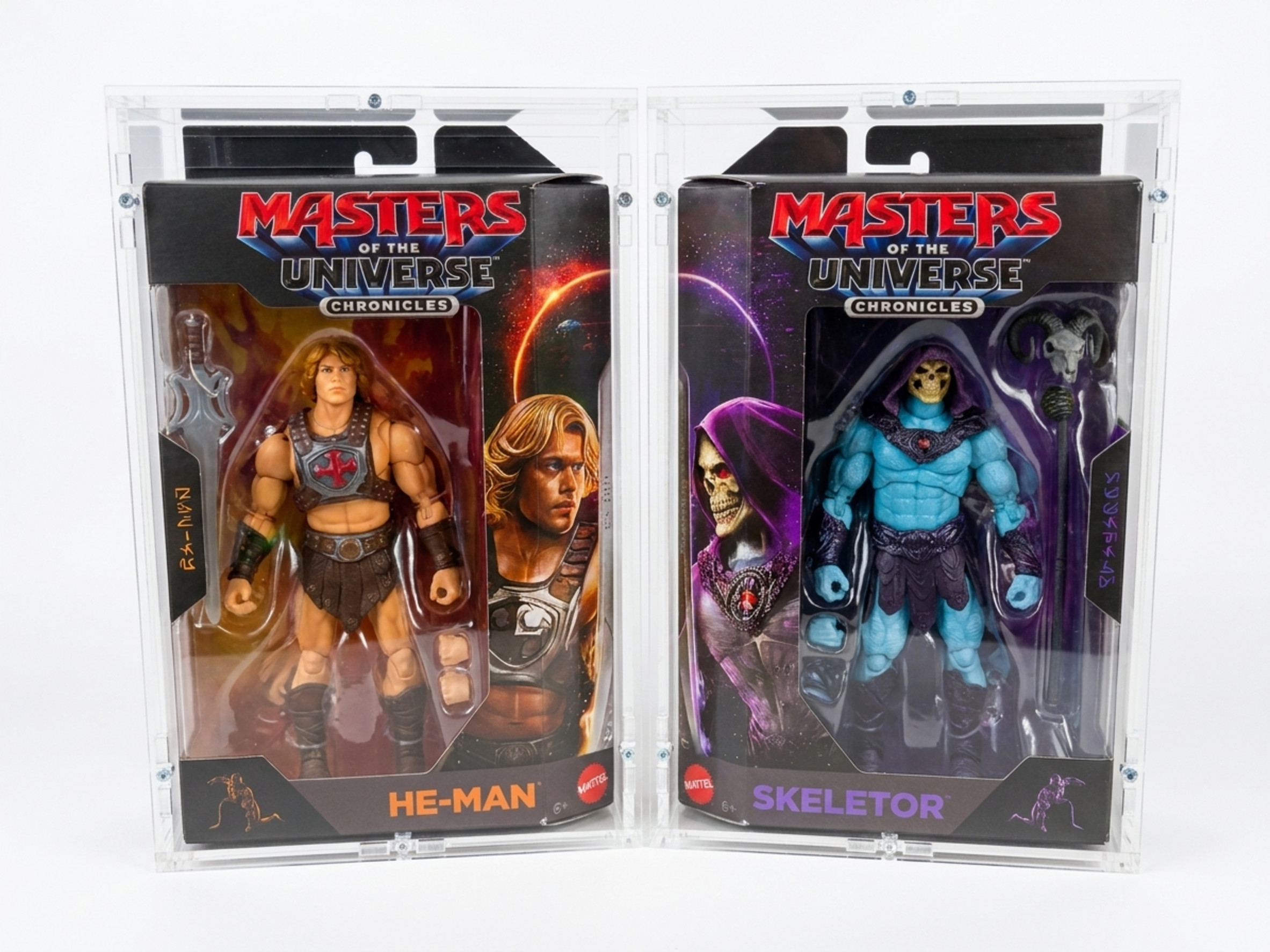 MotU Chronicles He-Man and Skeletor in their original packaging under precision-fit Sora acrylic cases