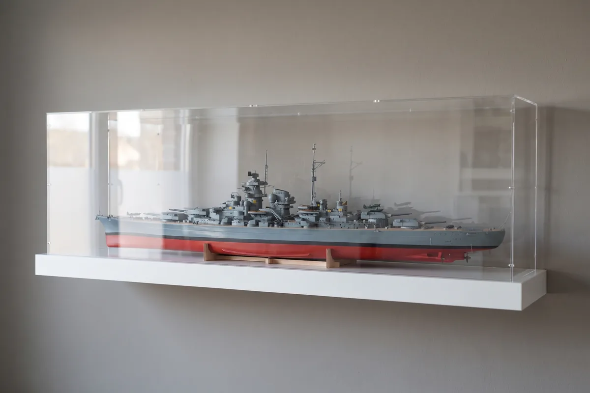 Battleship model in 1/350 scale under a long flat acrylic display case