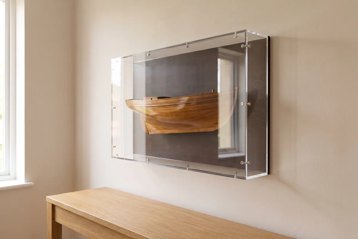 Ship half model in an acrylic display box mounted on a wall