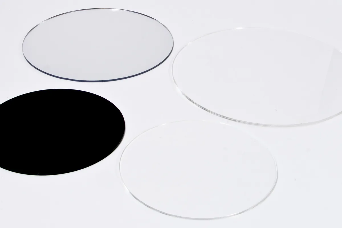 Four round acrylic discs cut to size: transparent, reflective and black