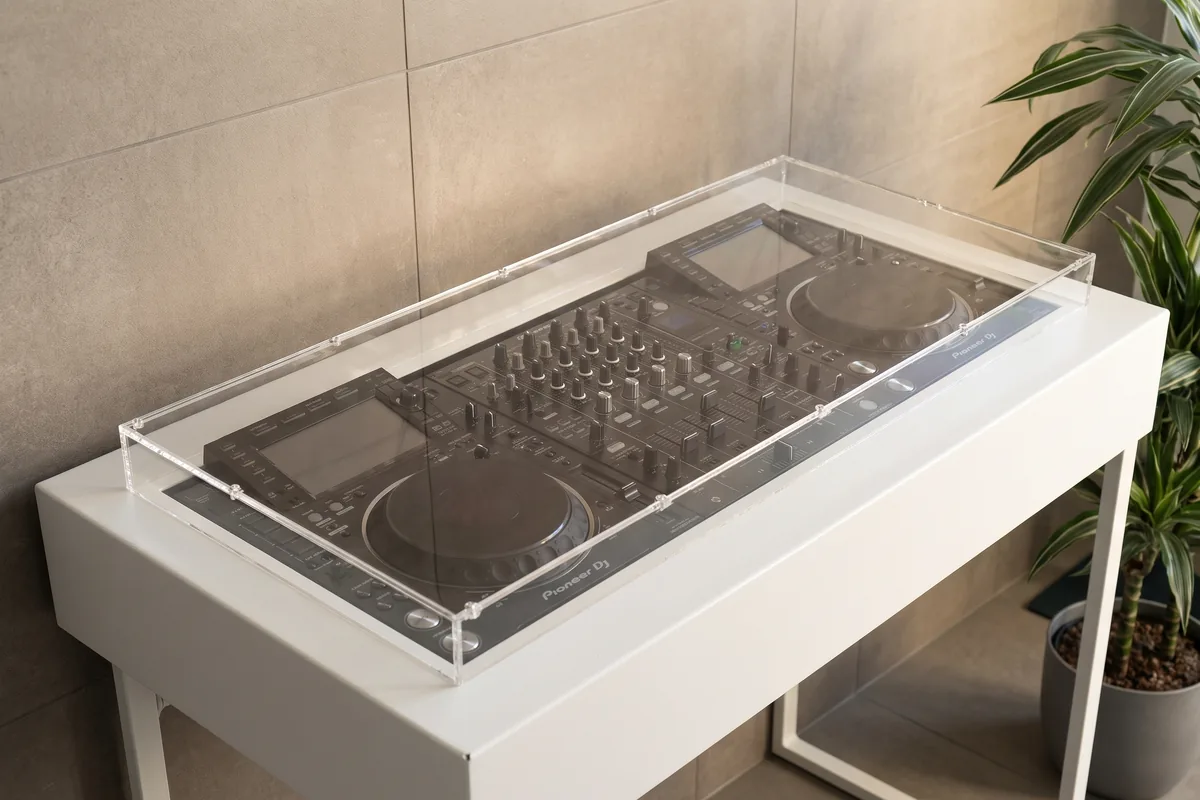Mixer with faders under a precisely fitting acrylic dust cover