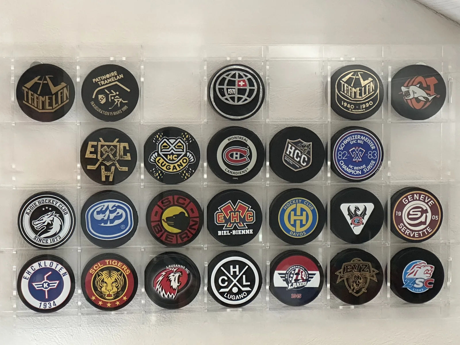 Shallow display cabinet with 28 compartments for an ice hockey puck collection